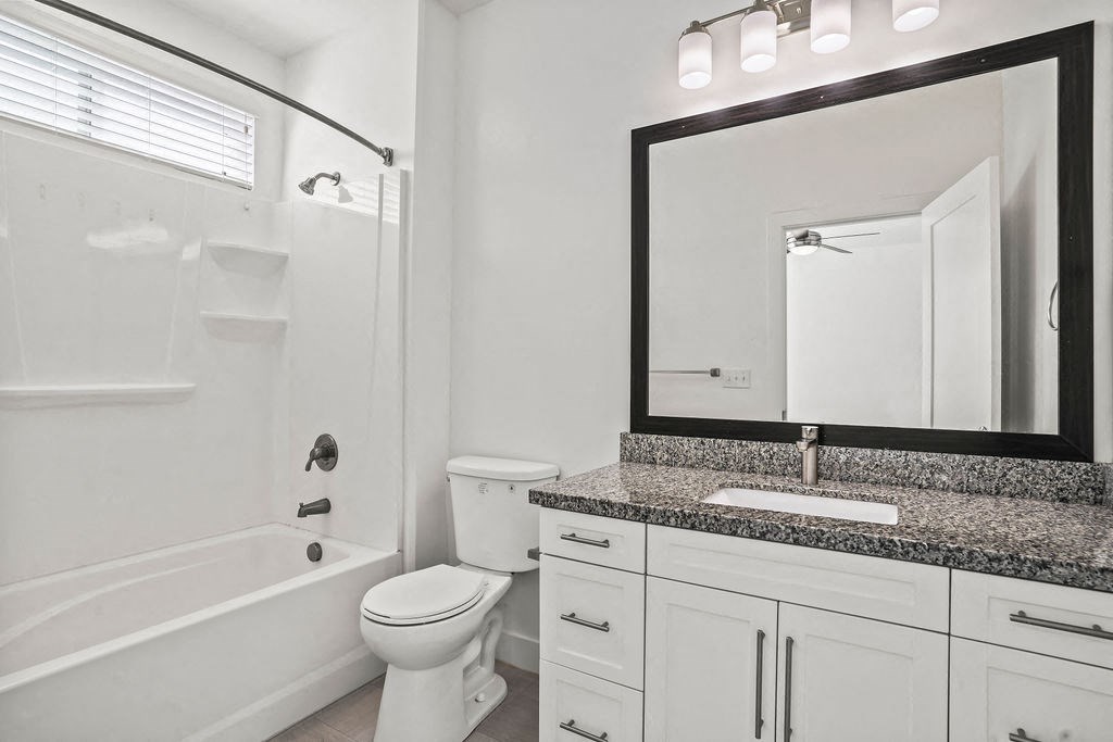 a bathroom with a sink toilet and a bath tub  at Aero Luxury Townhomes in Layton, Utah