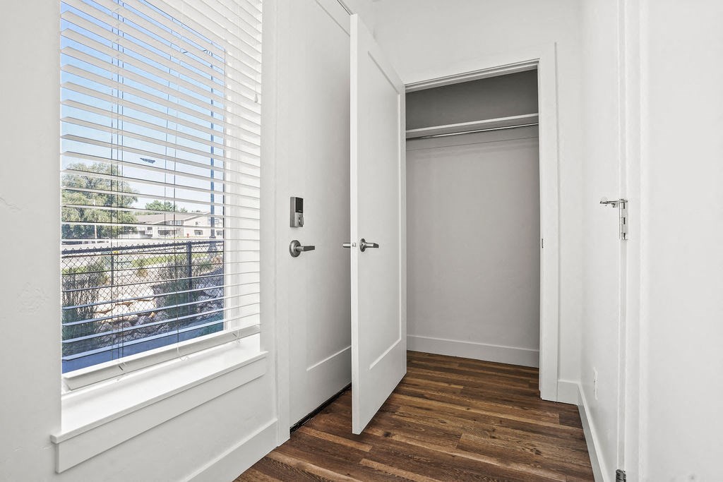 a bedroom with a window and a door to a closet  at Aero Luxury Townhomes in Layton, Utah