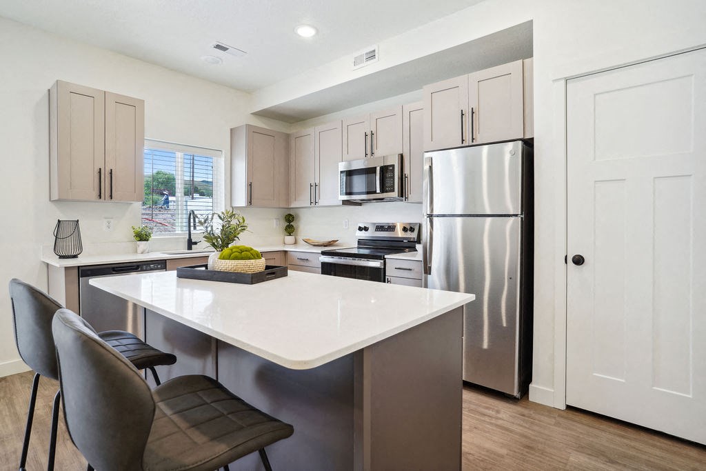 a kitchen with stainless steel appliances and a white counter top