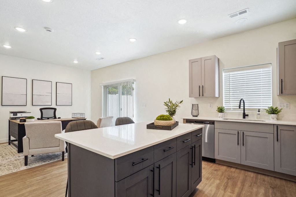 an open kitchen and living room with a table and chairs