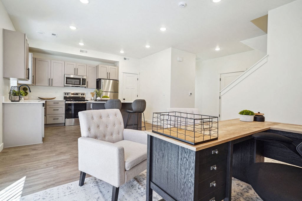 an open kitchen and living room with a counter top and a table