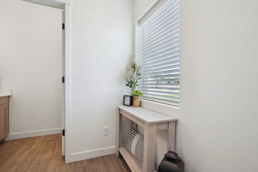 a room with a window and a table with a plant
