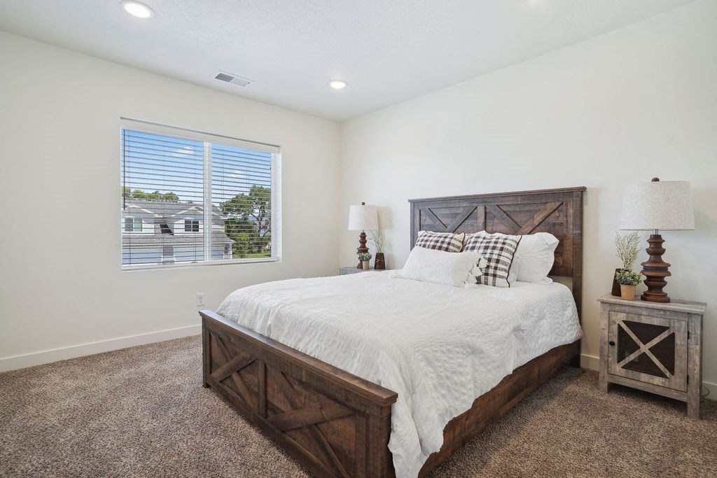 a bedroom with a bed and a window