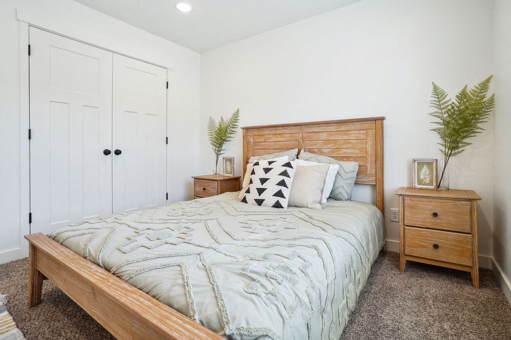 a bedroom with a bed and two chests of drawers