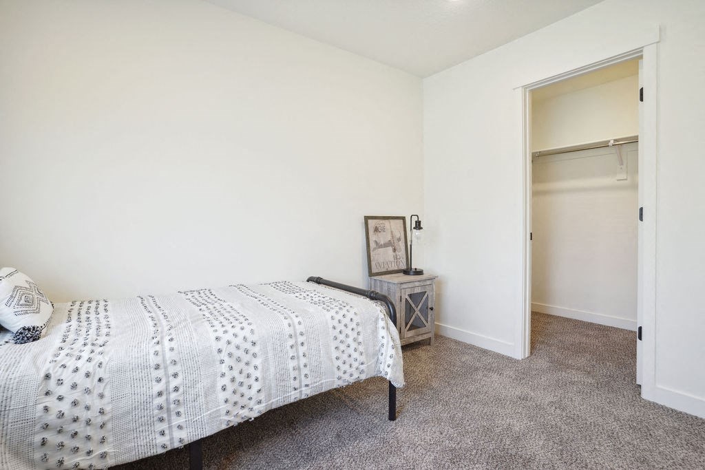 a bedroom with a bed and a closet