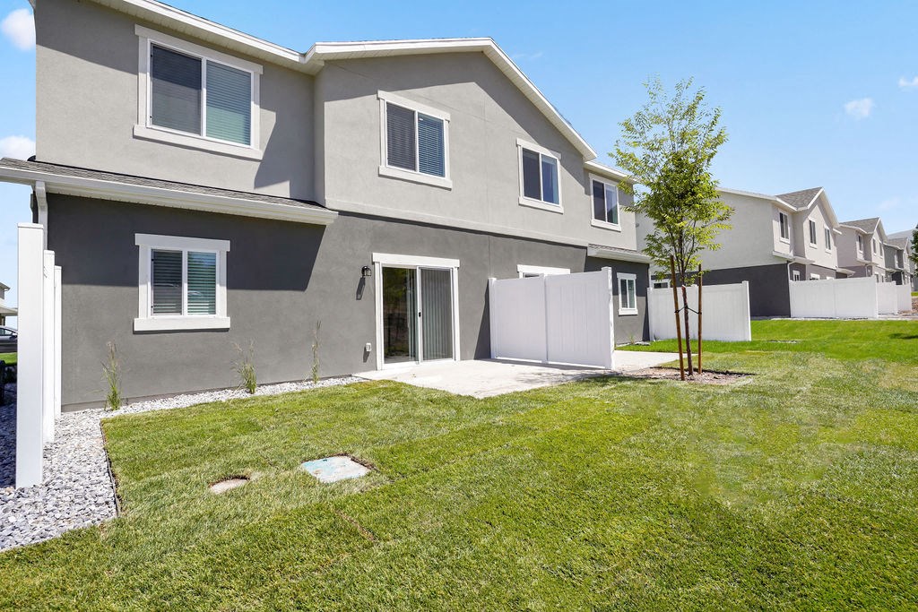 a row of houses with grass and trees in front of them