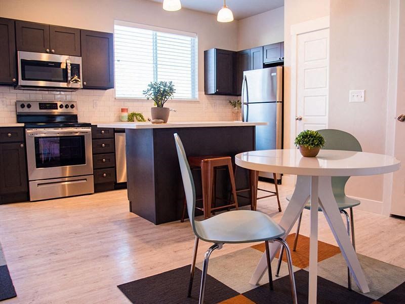 a kitchen with a table and a refrigerator