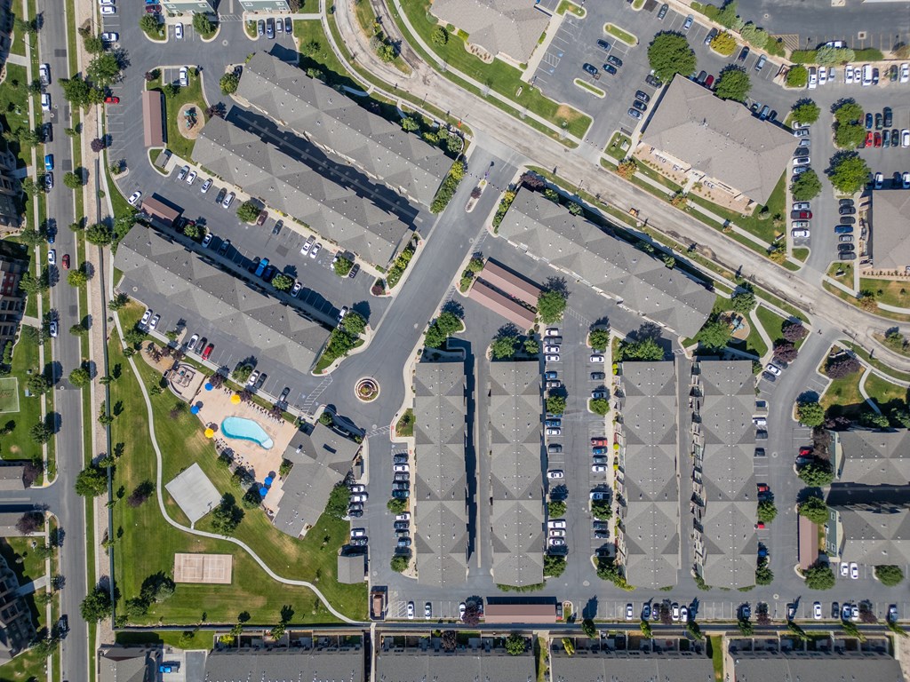 an aerial view of a parking lot and cars in a parking at Aldara Apartments in Saratoga Springs, Utah