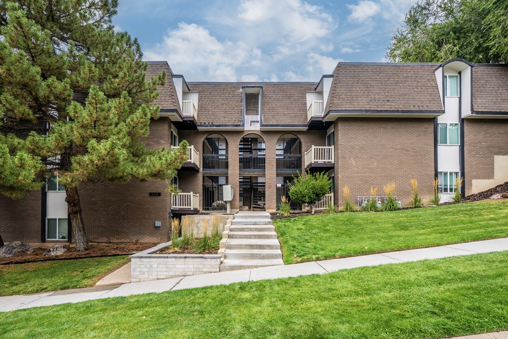 A large brown building with a white door and windows.