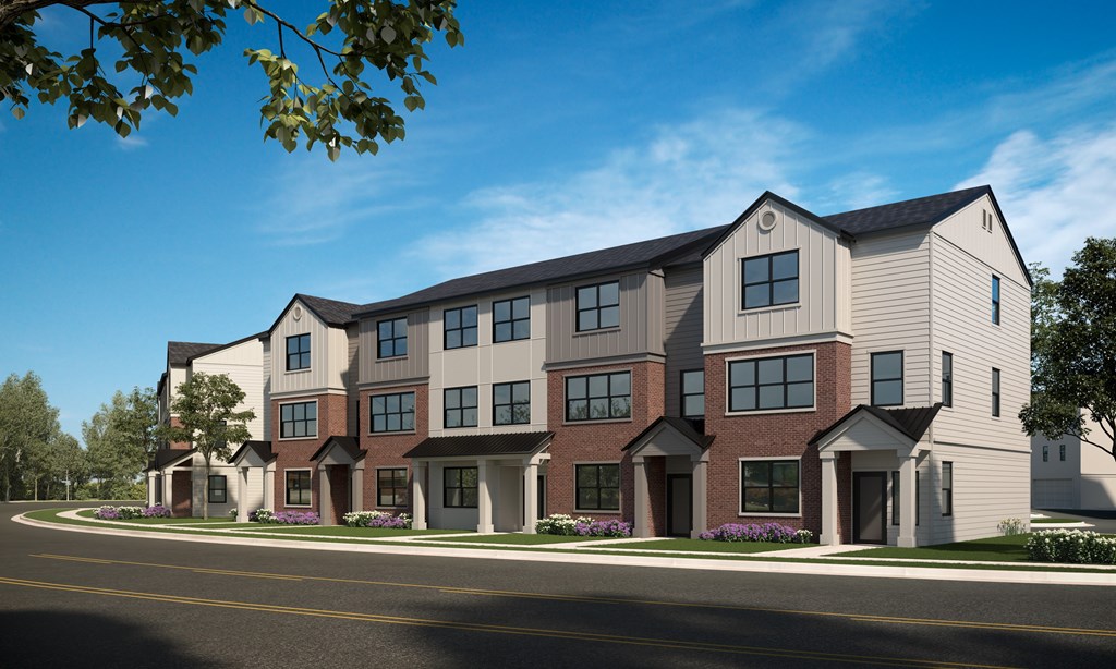 A modern apartment building with a mix of brick and siding exterior.