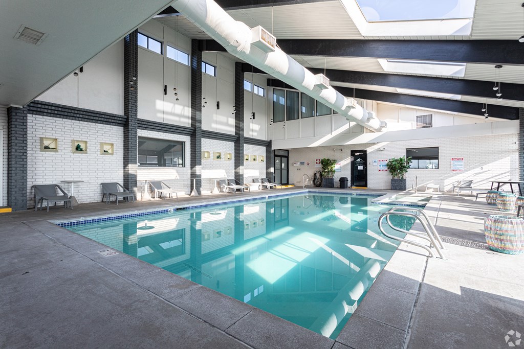 A large indoor swimming pool with a skylight above it.