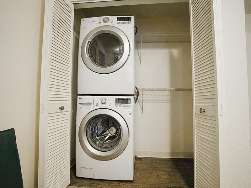 A white washing machine is in a small room.