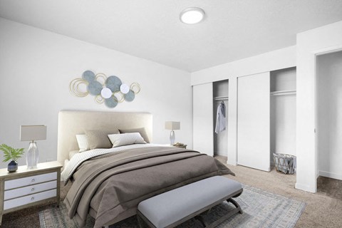 A bedroom with a large bed and a bench in front of it.
