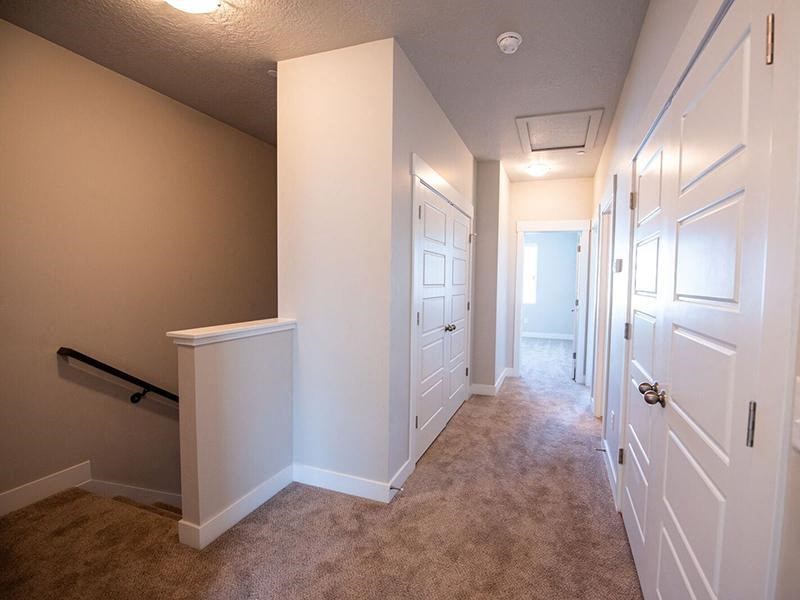 a hallway with white closets and white doors