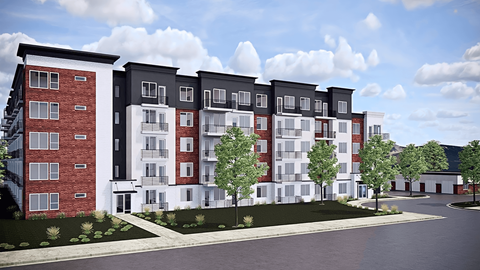 A modern apartment complex with red brick and white buildings.
