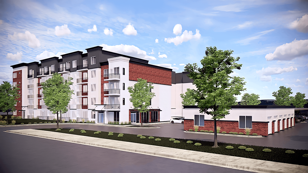 A modern apartment building with a parking lot in front.