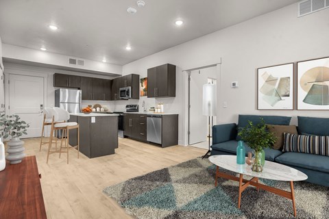 A modern kitchen with a dining table and a couch.
