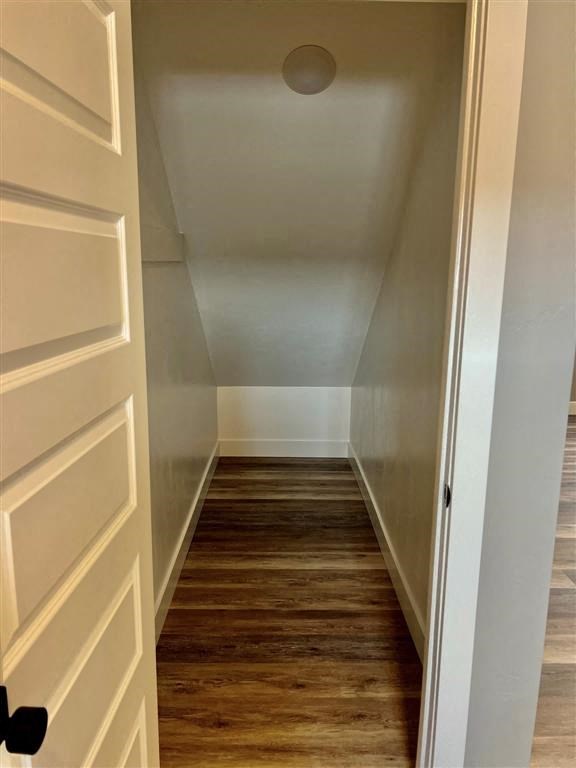 a hallway with a white door and wood floors
