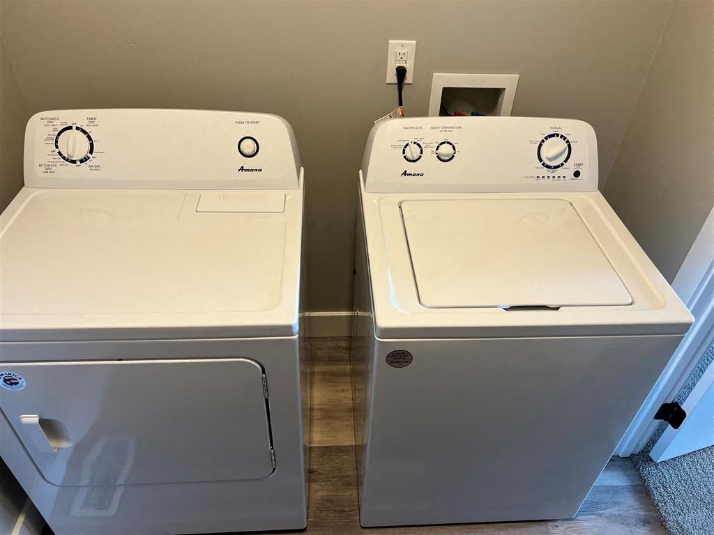 two washers and a dryer next to each other in a room