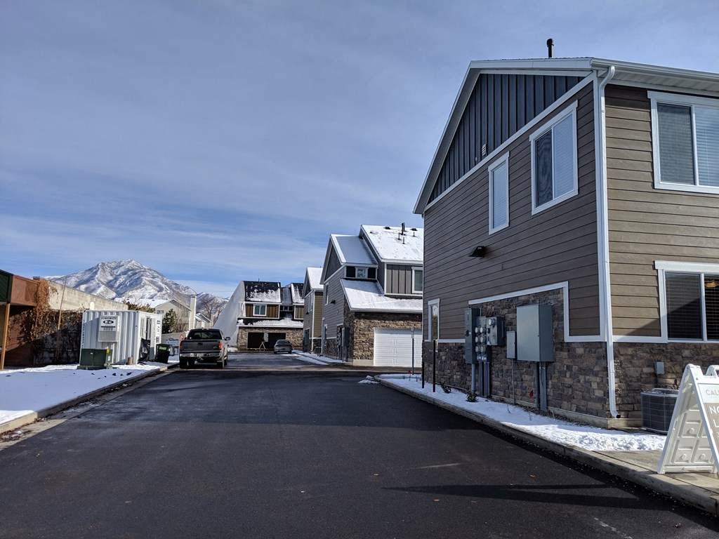 a street with houses and a mountain in the background