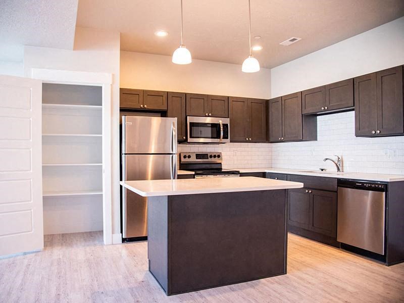 a kitchen with stainless steel appliances and a white counter top