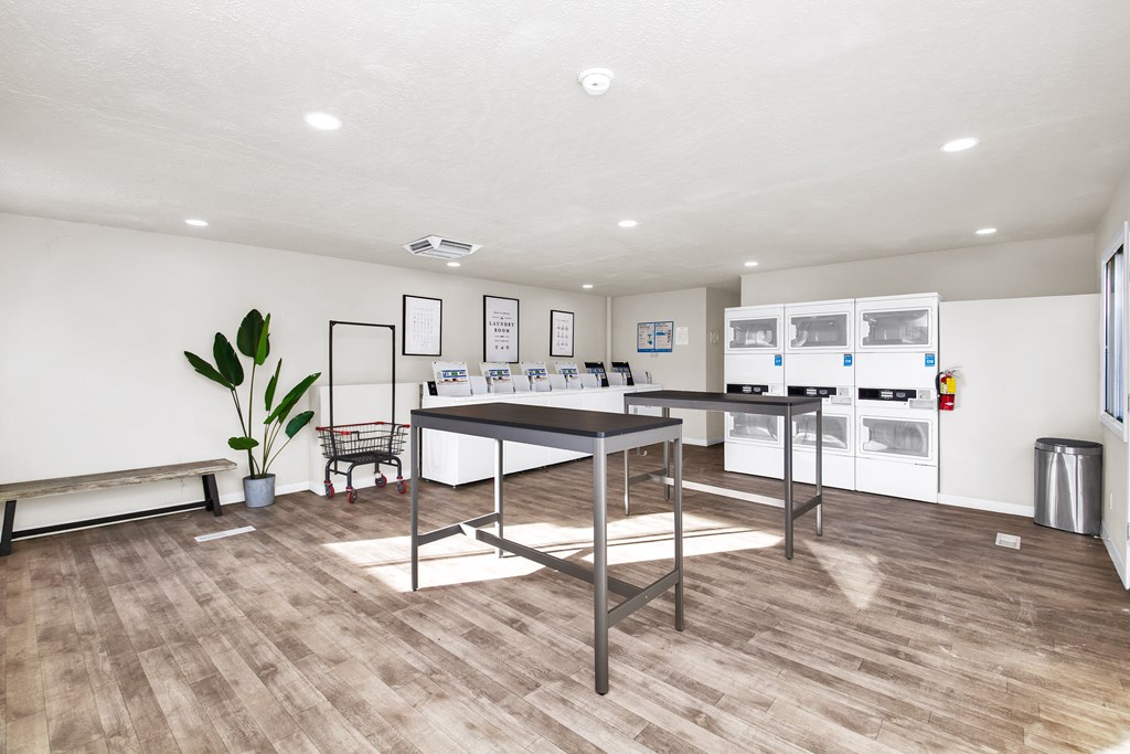 A kitchen with a table and chairs in the middle of the room.