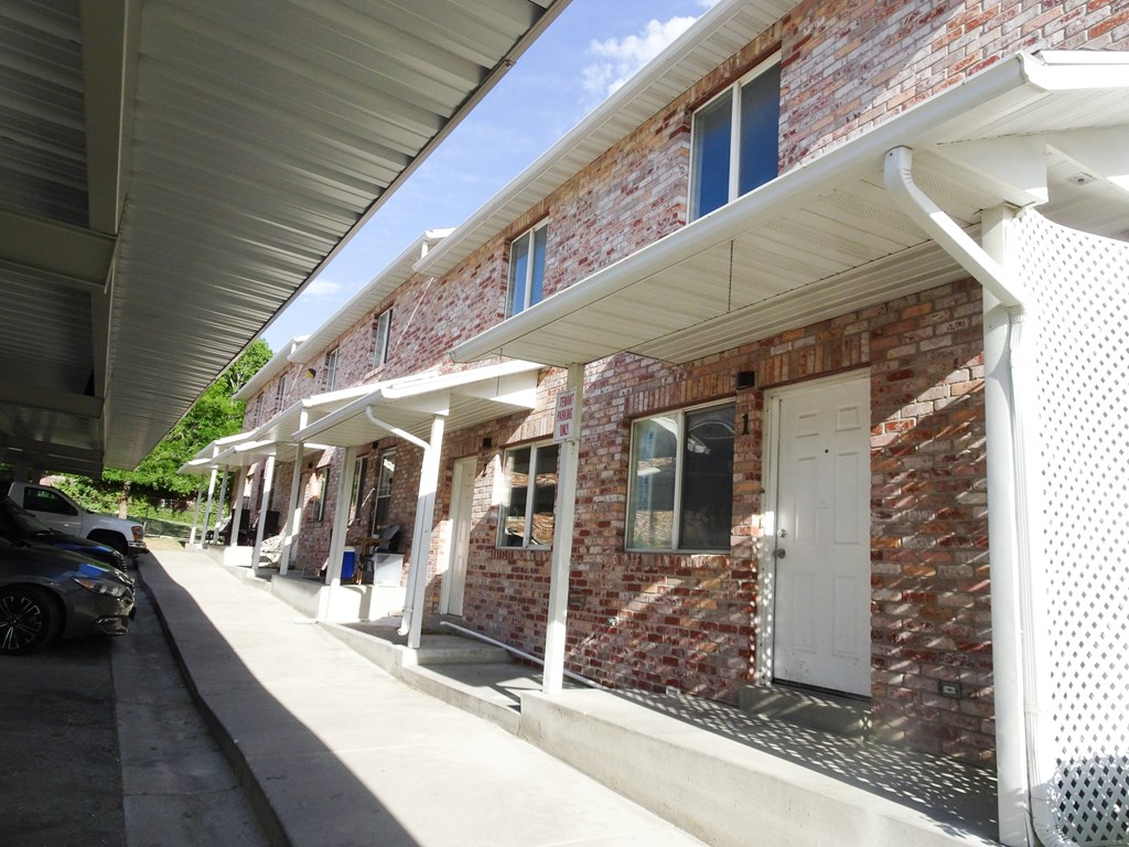 A red brick building with white trim and a white door.
