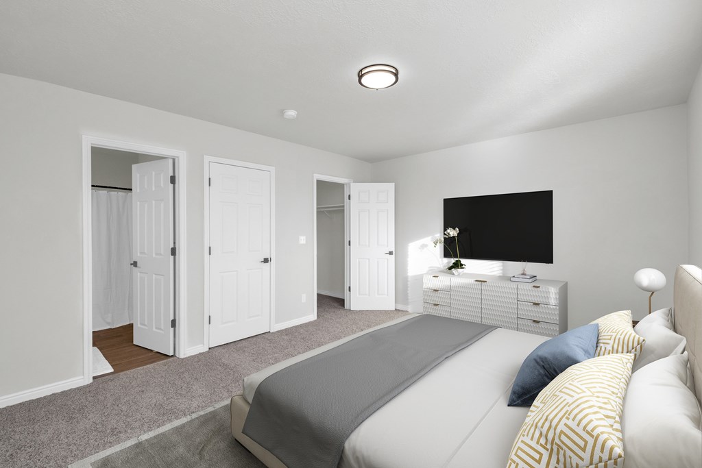 A bedroom with a bed, dresser, and wardrobe.