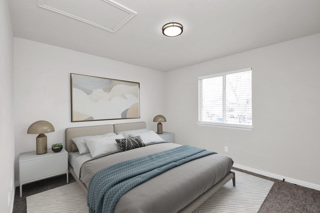 A bedroom with a bed, nightstands, and a painting on the wall.