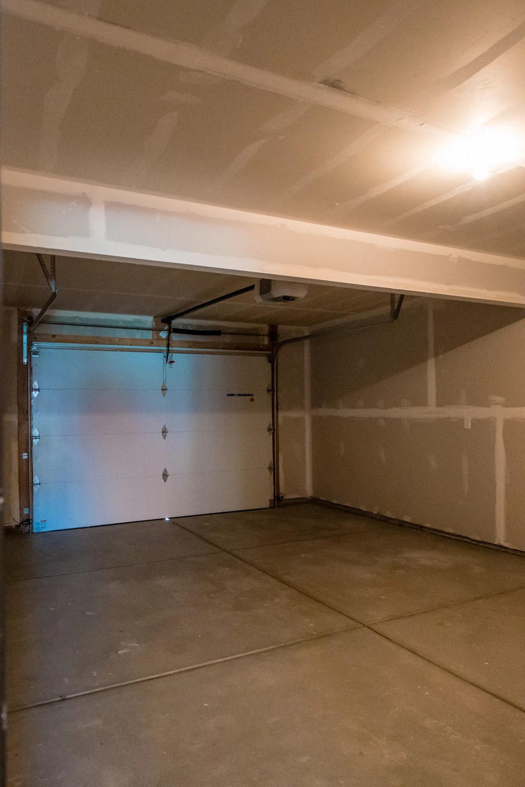 a garage with a white wall and a garage door