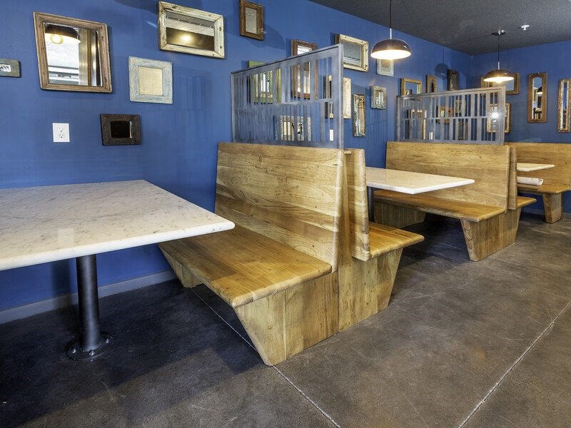 a restaurant with wooden benches and tables