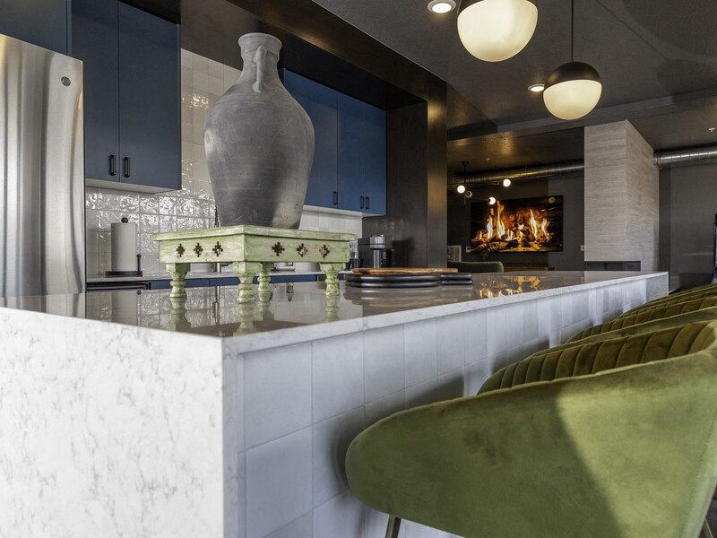 a kitchen with a marble counter top and a fireplace