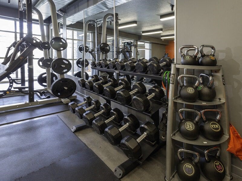 a gym with a lot of weights on a rack