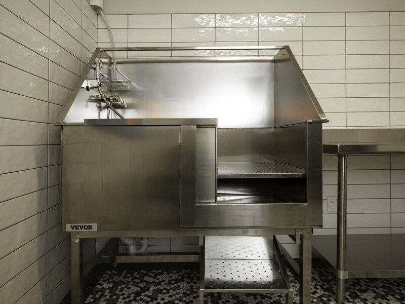 a kitchen with a stainless steel stove and a stool