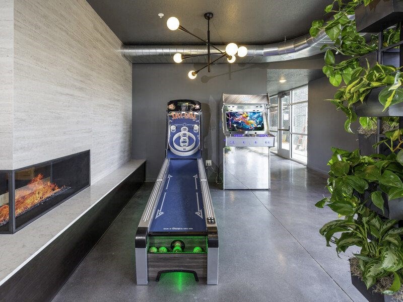 a room with a video game and a gas fireplace