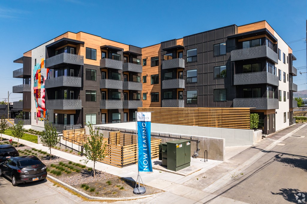 an apartment building with a sign in front of it at Lotus Gallacher luxury apartments for rent in Salt Lake City, UT