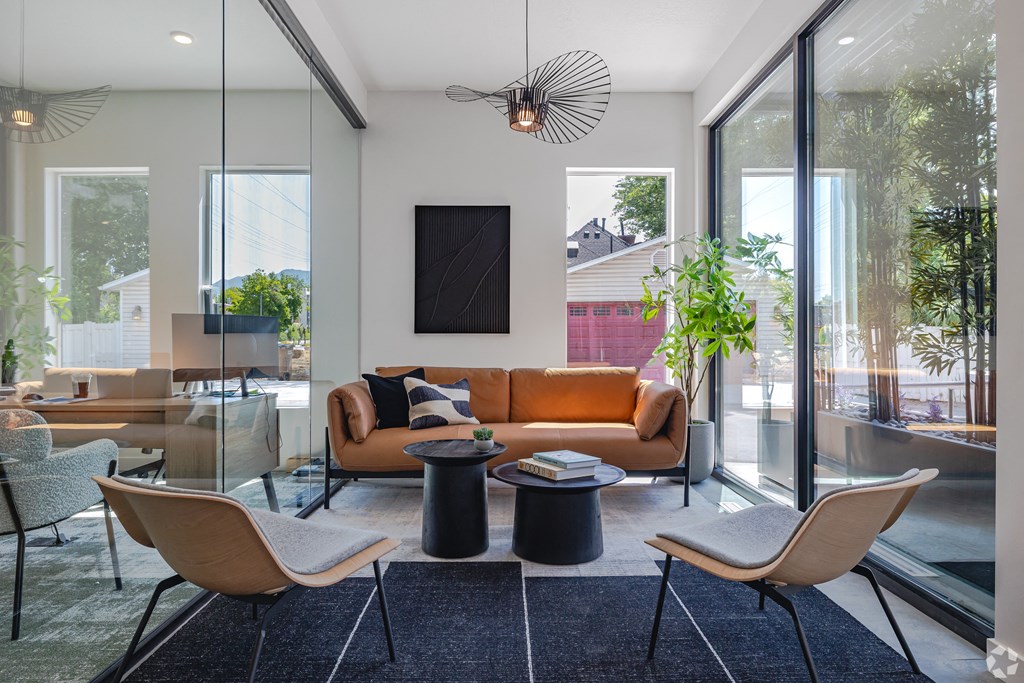 a living room with a couch and chairs and a table at Lotus Gallacher luxury apartments for rent in Salt Lake City, UT