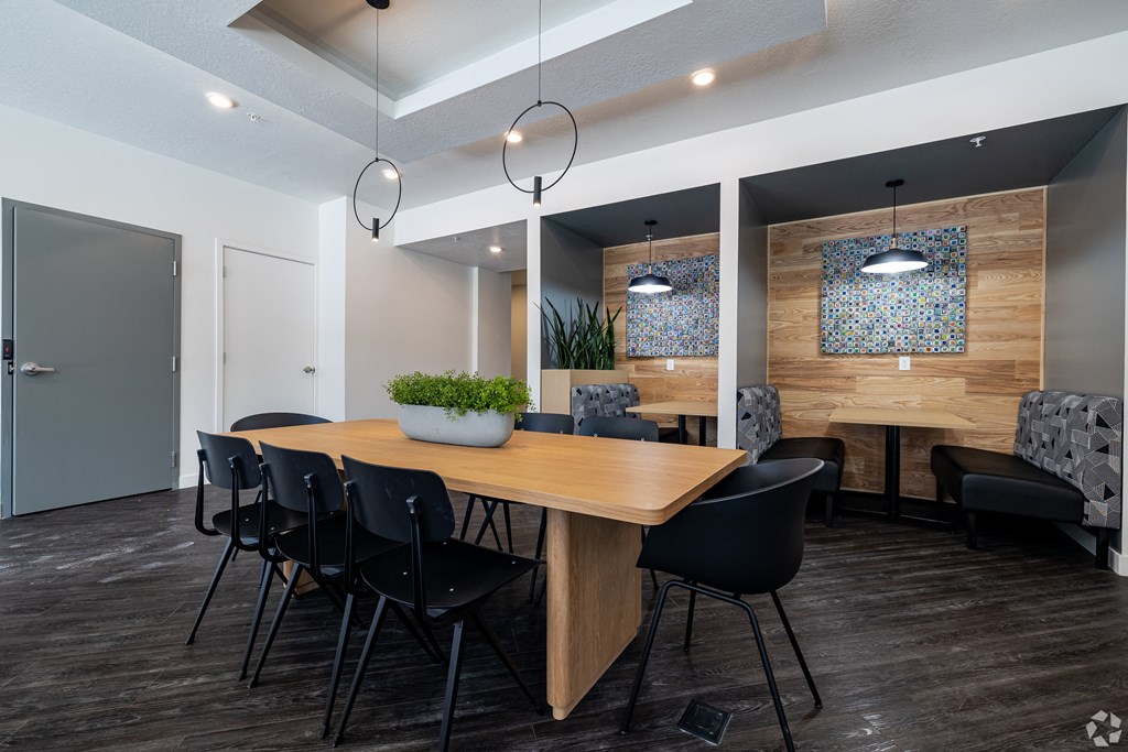 a dining room with a wooden table and chairs at Lotus Gallacher luxury apartments for rent in Salt Lake City, UT