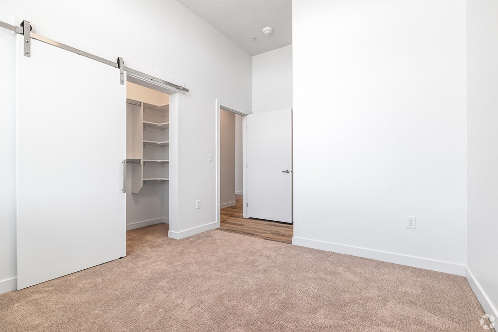 an empty room with a closet and a carpeted floor at Lotus Gallacher luxury apartments for rent in Salt Lake City, UT