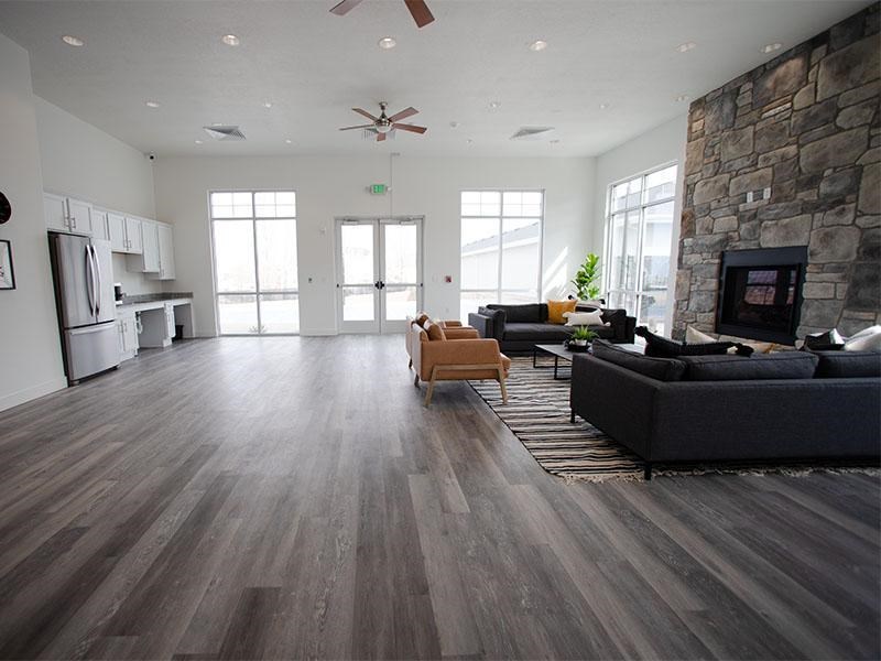 A living room with a stone wall and a fireplace.