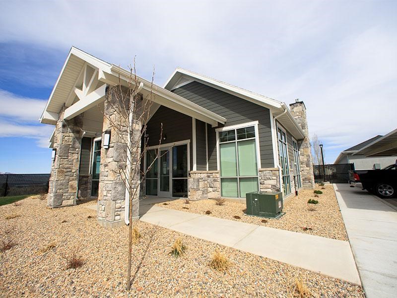 A house with a stone pillar and a green door.