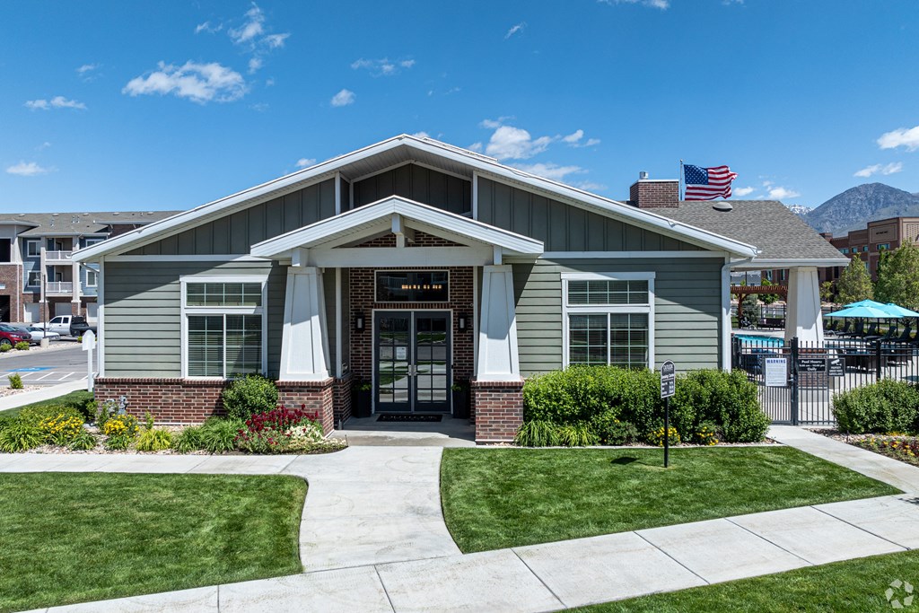 clubhouse building entrance with green grass at Outlook Apartments for rent in Springville and Provo, UT.