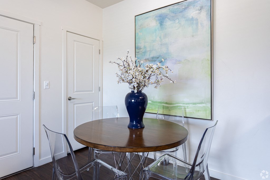 a dining room with a table and art at Outlook Apartments for rent in Springville and Provo, UT.