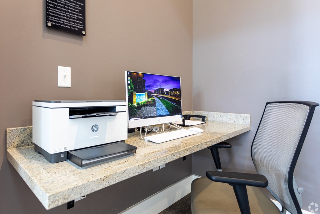 an office with a computer and printer on a desk in an office area at Outlook Apartments for rent in Springville and Provo, UT.