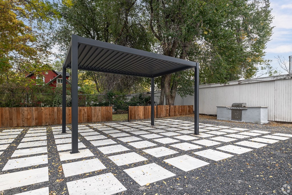 A black and white checkered pavement with a black metal canopy.