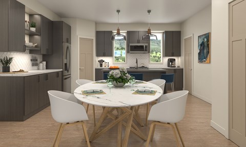 A modern kitchen with a dining table set for two.