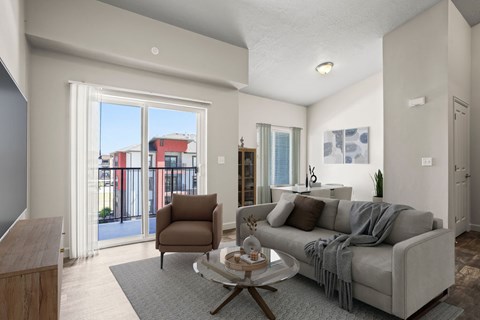 A living room with a grey couch and a brown chair.