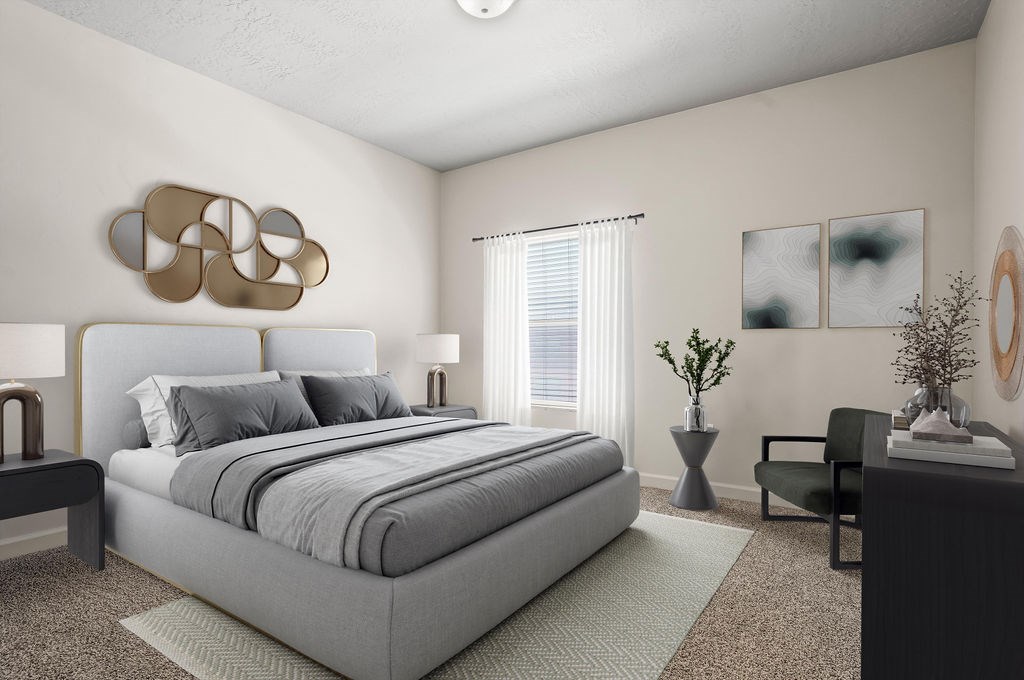 A modern bedroom with a large bed and a grey carpet.