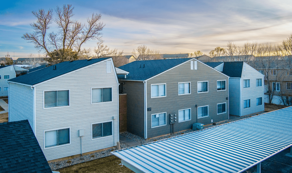 A row of houses with a metal roof.