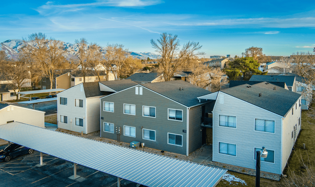 A modern building with a parking lot in front.